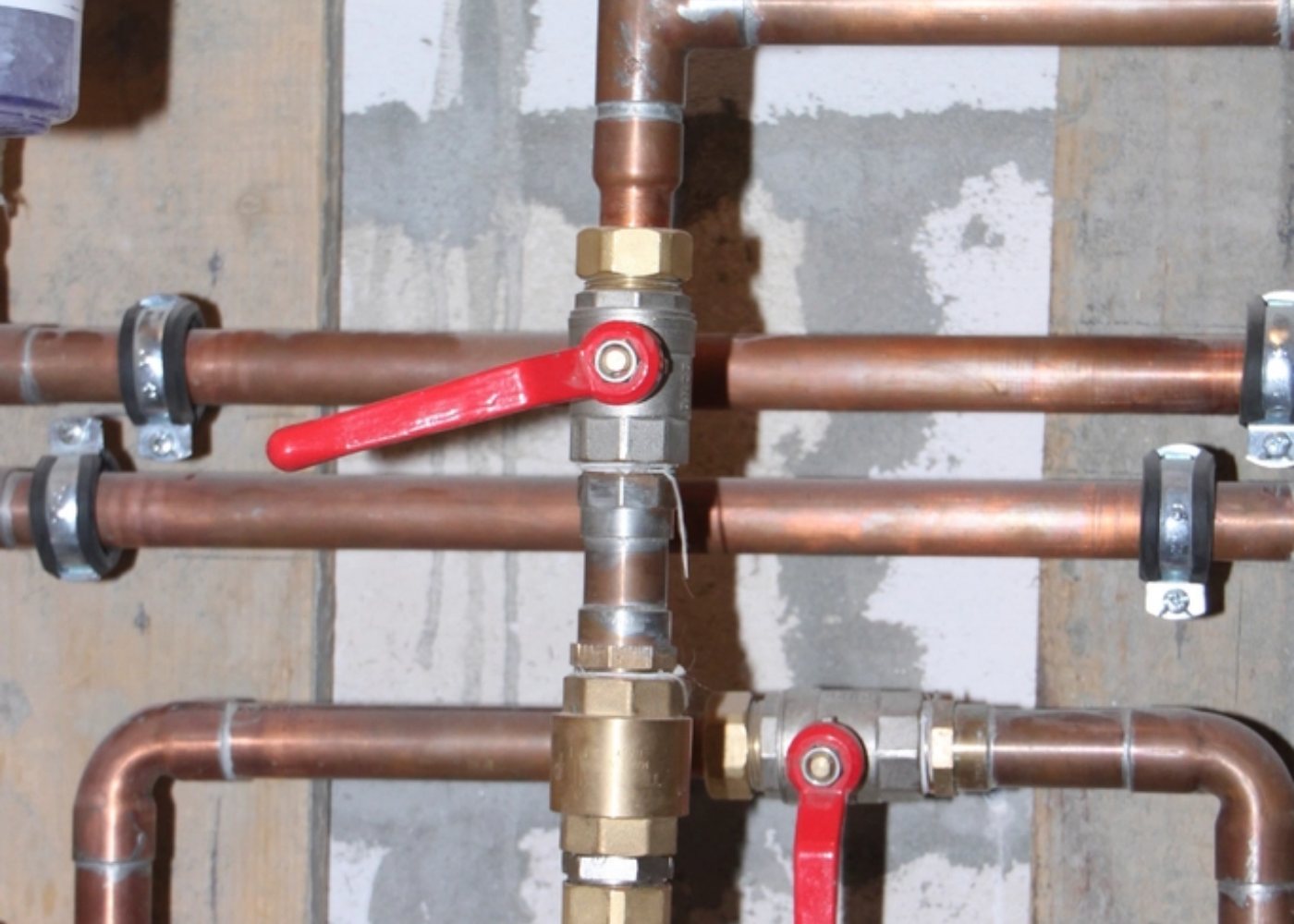 Copper supply lines with isolating valves (illustrative stock photograph)